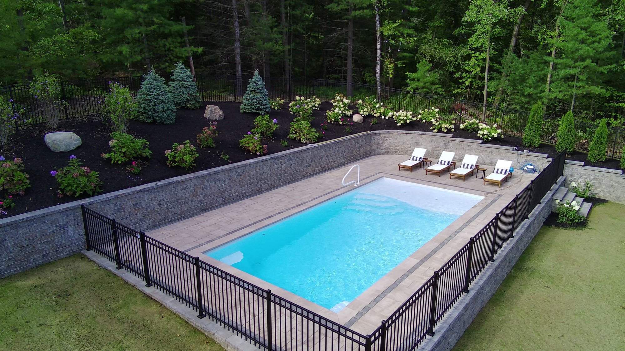 Architecturally designed swimming pool with clean geometric lines and a spacious poolside layout