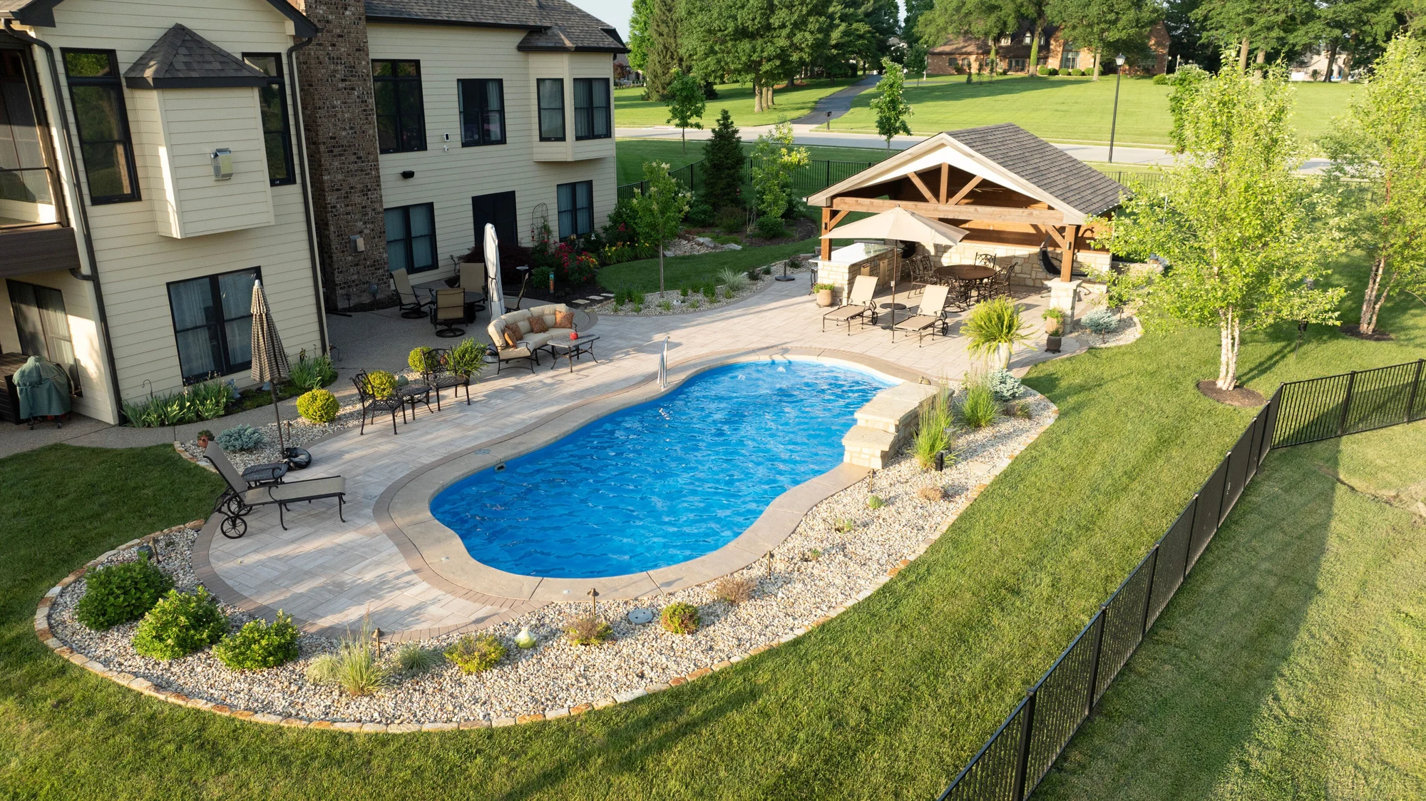 Beautiful custom swimming pool with refined architectural lines, clear blue water and a carefully designed outdoor setting