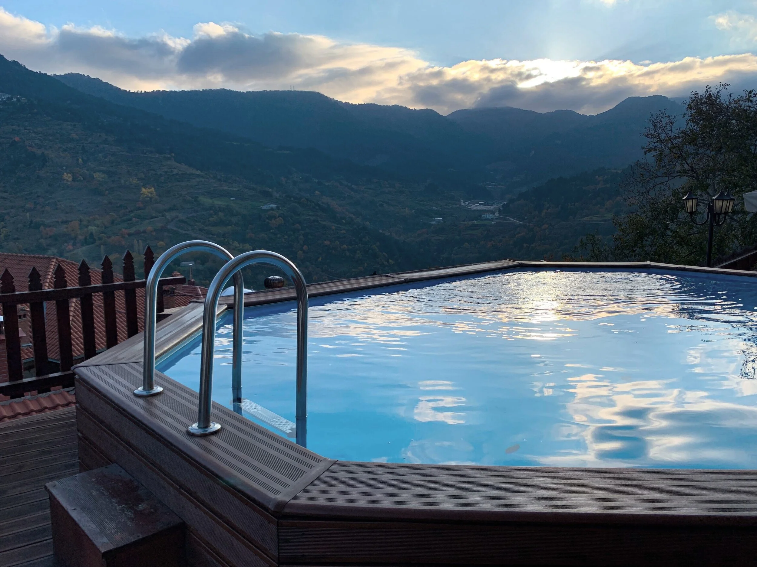 Contemporary backyard swimming pool with elegant water features and a thoughtfully designed outdoor relaxation area